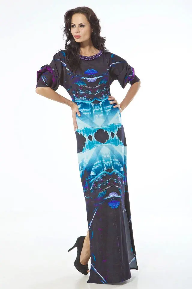 Model wearing a long cotton jersey thobe-style dress with full sleeves, printed in icy blue, purple, and black, featuring side slits from the knee.